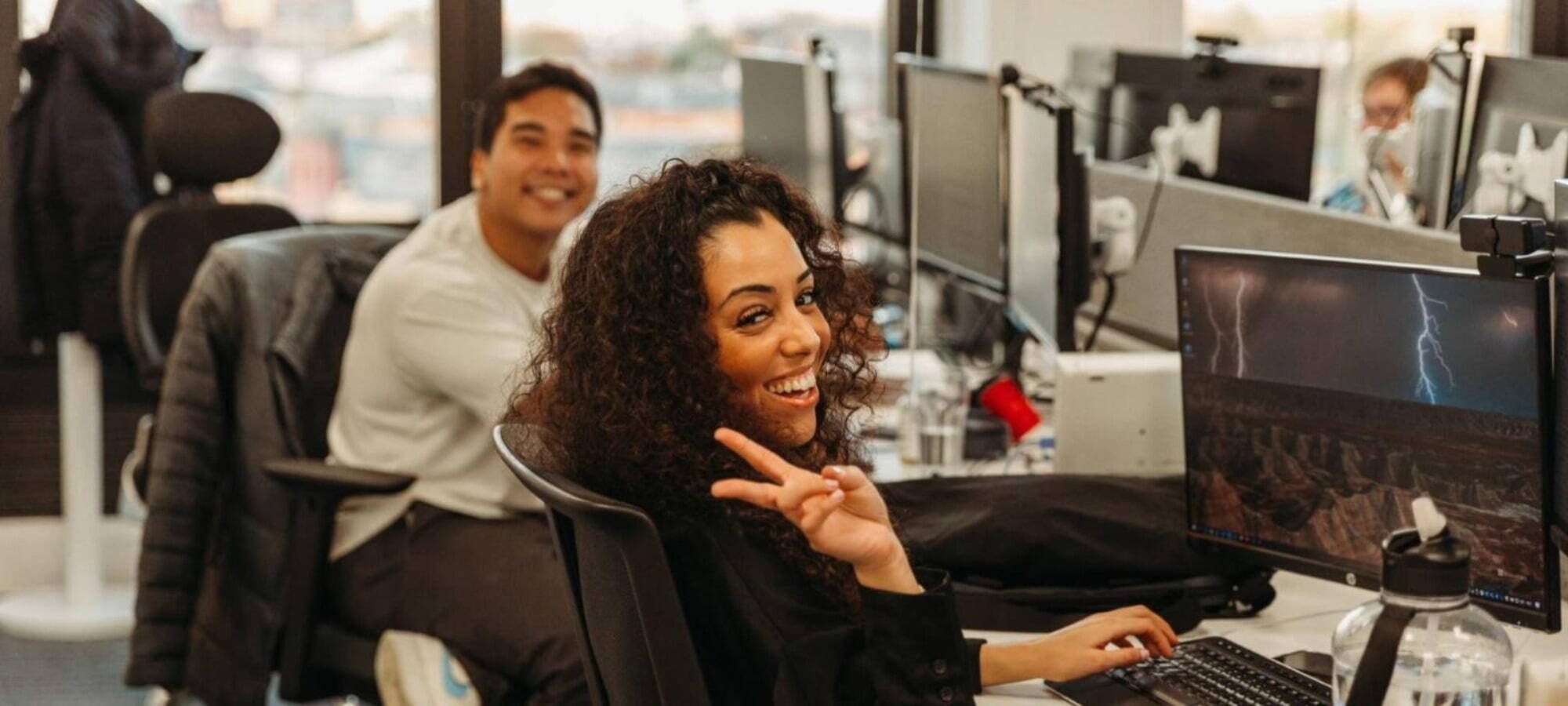 male and female employees in the ersg office smiling 