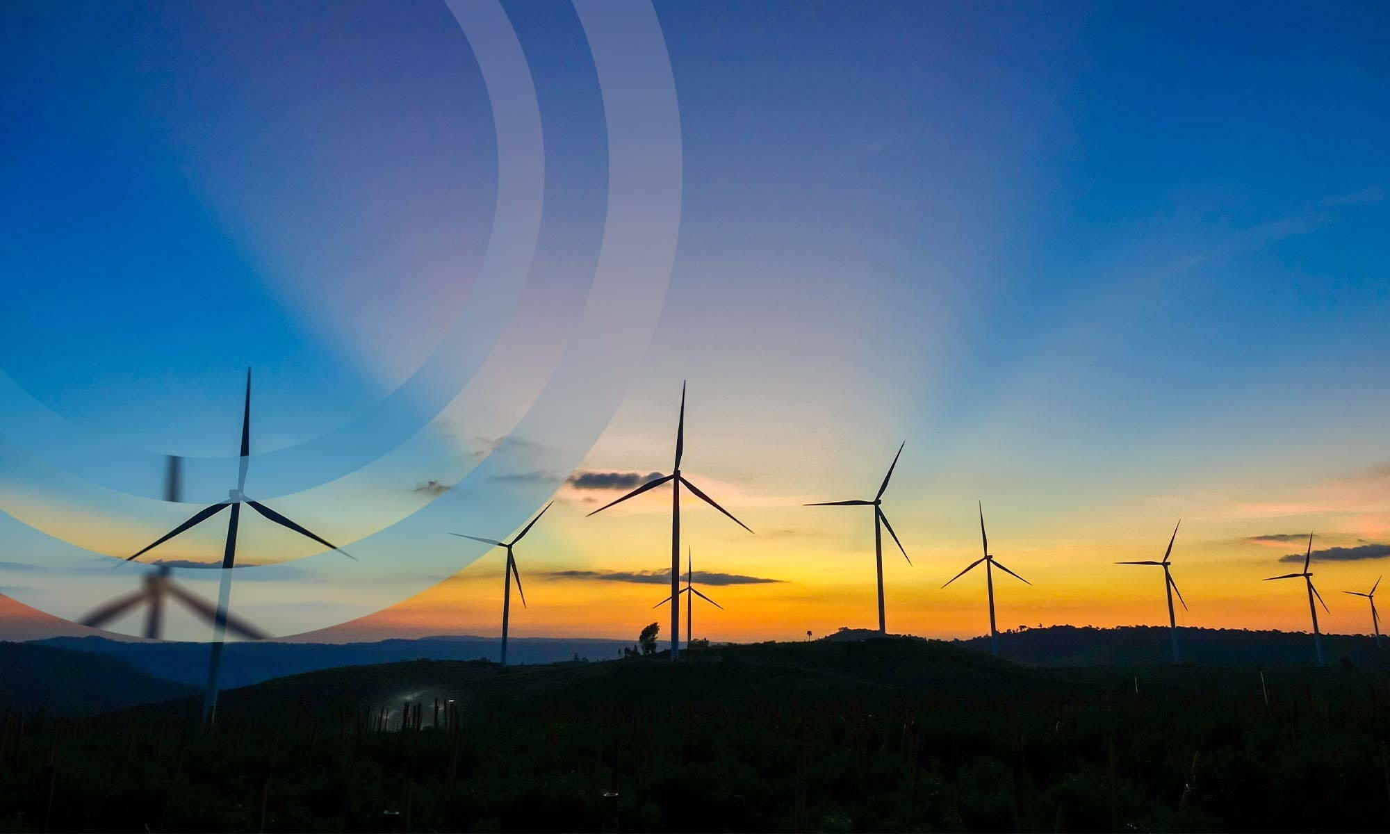 Onshore wind farm with beautiful sunset, blue and yellow skies with shadow